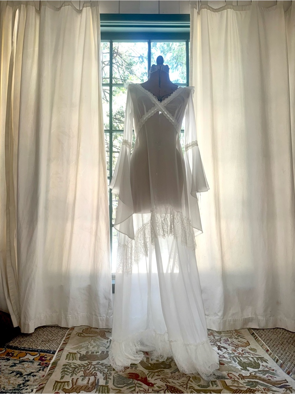Elegant White Flowing Maxi Dress with Lace Trim and Bell Sleeves